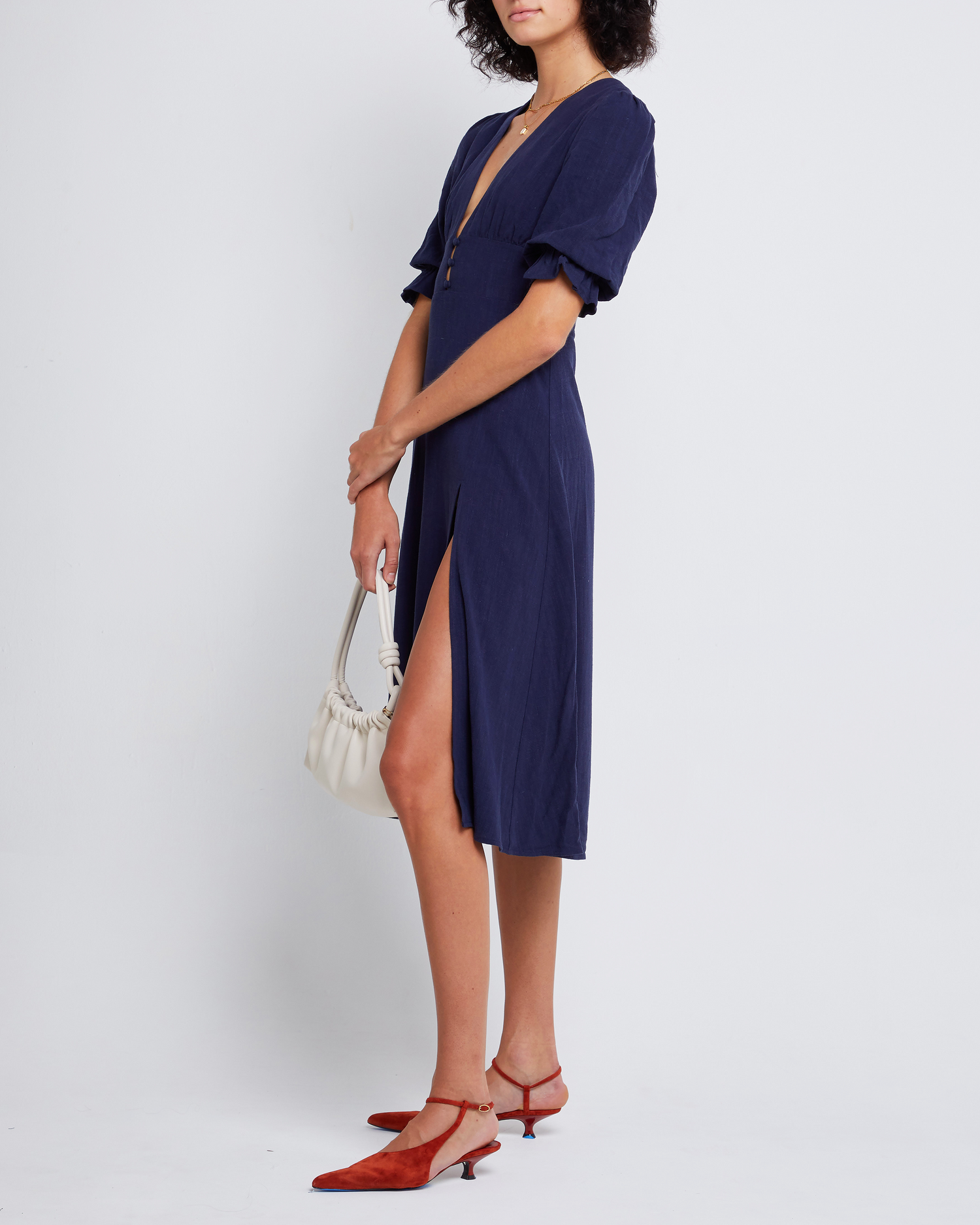 Third image of Julien Dress, a blue midi dress, V-neck, plunge neck, 3/4 sleeves, puff sleeves, side slit, front buttons