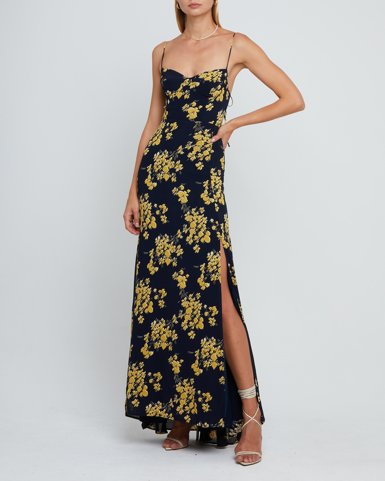 Sixth image of Delphi Dress, a navy and yellow floral maxi-length bridesmaid dress with sweetheart neckline, cup detail, side slit, cupped sweetheart neckline, back zipper, back smocking, and adjustable tie string straps